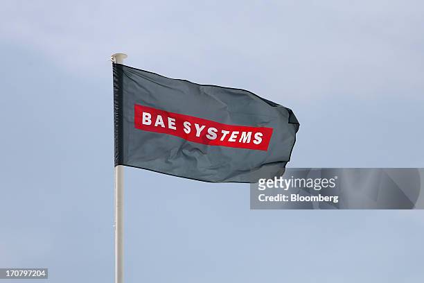 Logo sits on a flag as it flies above the BAE Systems Plc's chalet on the second day of the Paris Air Show in Paris, France, on Tuesday, June 18,...