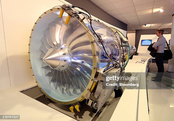 Visitor looks at a PW300 aircraft engine manufactured by Pratt & Whitney, a unit of United Technologies Corp., on the second day of the Paris Air...