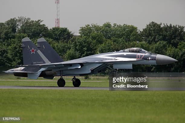 Sukhoi Co. Holding OAO SU-35 fighter jet lands after participating in a flying display on the second day of the Paris Air Show in Paris, France, on...