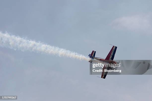 An Extra 330 aircraft performs in a flying display on the second day of the Paris Air Show in Paris, France, on Tuesday, June 18, 2013. The 50th...