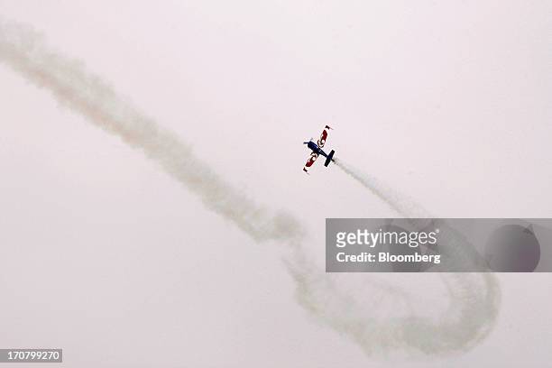 An Extra 330 aircraft performs in a flying display on the second day of the Paris Air Show in Paris, France, on Tuesday, June 18, 2013. The 50th...