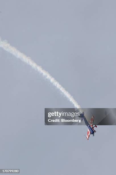 An Extra 330 aircraft performs in a flying display on the second day of the Paris Air Show in Paris, France, on Tuesday, June 18, 2013. The 50th...