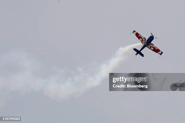 An Extra 330 aircraft performs in a flying display on the second day of the Paris Air Show in Paris, France, on Tuesday, June 18, 2013. The 50th...