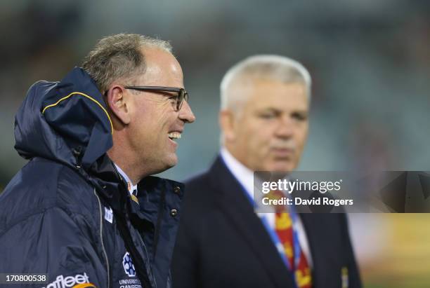 Jake White, the Brumbies head coach smiles as Warren Gatland the Lions head coach looks on during the International tour match between the ACT...