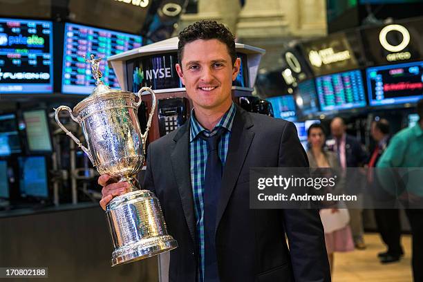 Golfer Justin Rose poses for a photo with the U.S. Open trophy on the floor of the New York Stock Exchange after joining the cast of CNBC's "Squawk...