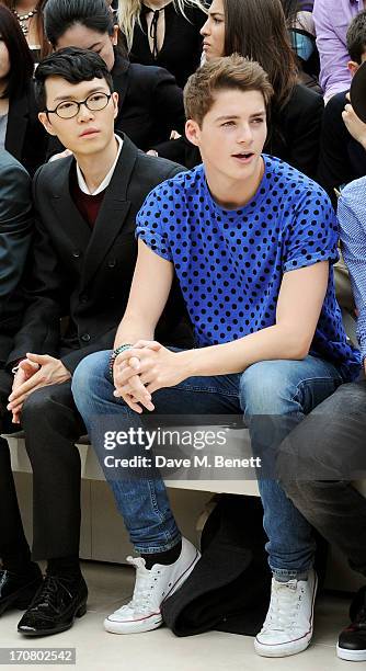 Khalil Fong and Finn Harries sit in the front row at Burberry Menswear Spring/Summer 2014 at Kensington Gardens on June 18, 2013 in London, England.
