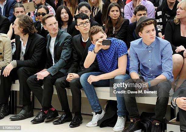 Gabriel Burce, Dan Gillespie Sells, Khalil Fong, Finn Harries and Jack Harries sit in the front row at Burberry Menswear Spring/Summer 2014 at...