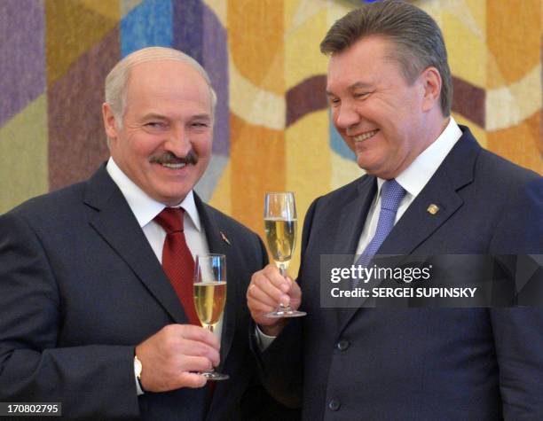 Belarussian President Alexander Lukashenko and his Ukrainian counterpart Viktor Yanukovych toast on June 18, 2013 after a document signing ceremony...