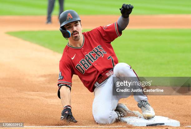 Corbin Carroll of the Arizona Diamondbacks slides into third base for a triple during the third inning in the game against the Chicago White Sox at...
