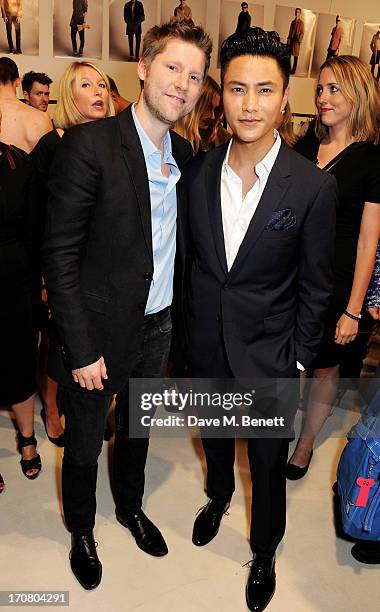 Burberry Chief Creative Officer Chrsitopher Bailey and Chen Kun pose backstage at Burberry Menswear Spring/Summer 2014 at Kensington Gardens on June...