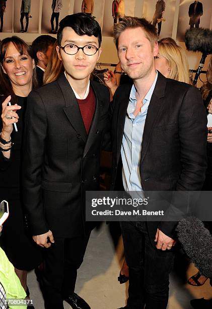 Khalil Fong and Burberry Chief Creative Officer Christopher Bailey pose backstage at Burberry Menswear Spring/Summer 2014 at Kensington Gardens on...