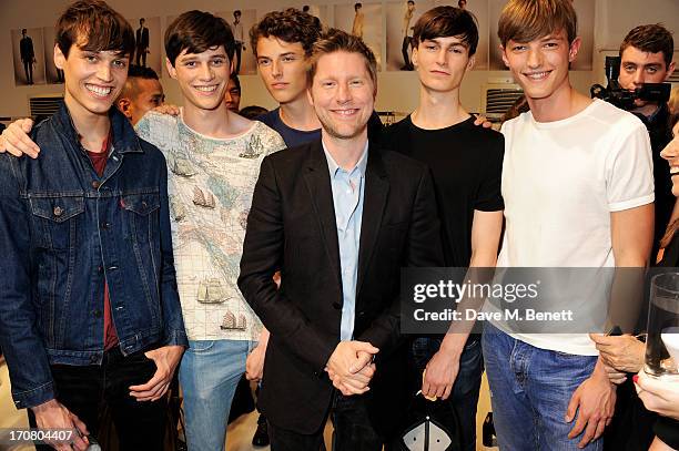 Burberry Chief Creative Officer Christopher Bailey poses with models at Burberry Menswear Spring/Summer 2014 at Kensington Gardens on June 18, 2013...