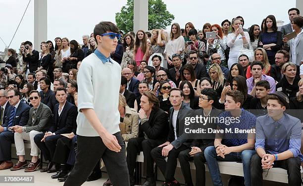 Guests including Gabriel Burce, Dan Gillespie Sells, Khalil Fong, Finn Harries and Jack Harries sit in the front row at Burberry Menswear...
