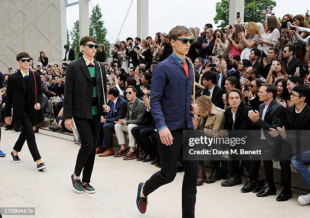 Guests including Jamie Campbell Bower, Gabriel Burce, Dan Gillespie Sells and Khalil Fong sit in the front row at Burberry Menswear Spring/Summer...