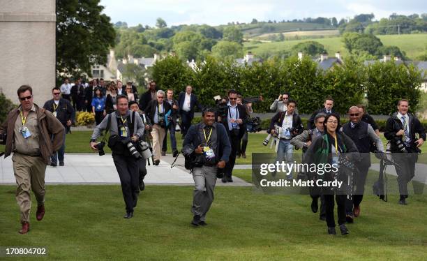 The international media arrive for the 'family' group photograph at the G8 venue of Lough Erne on June 18, 2013 in Enniskillen, Northern Ireland. The...