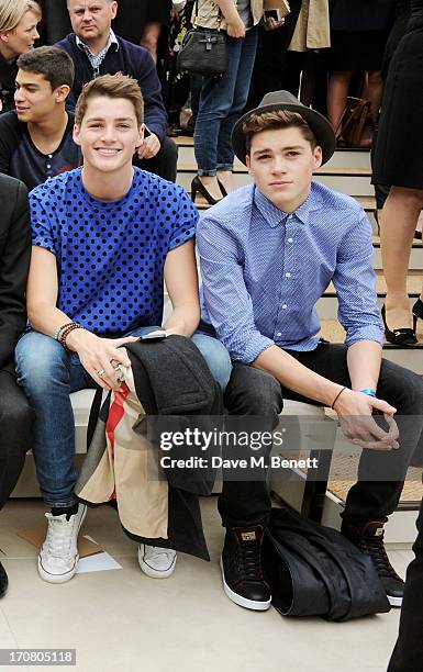 Finn Harries and Jack Harries attend the front row at Burberry Menswear Spring/Summer 2014 at Kensington Gardens on June 18, 2013 in London, England.