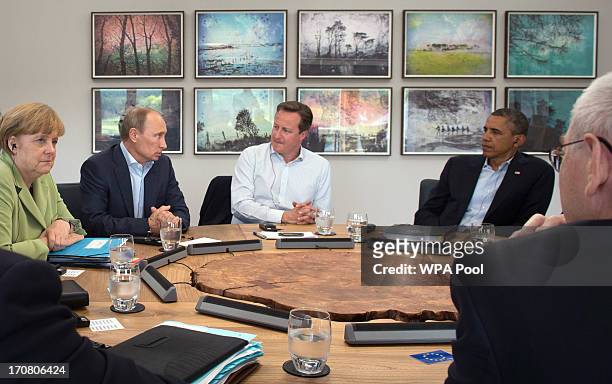 Russian President Vladimir Putin speaks as Prime Minister David Cameron holds a meeting with G8 leaders at the G8 venue of Lough Erne on June 18,...