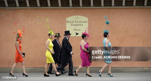 Racegoers walk along the street as they arrive during the first day of Royal Ascot, in Berkshire, west of London, on June 18, 2013. The five-day...