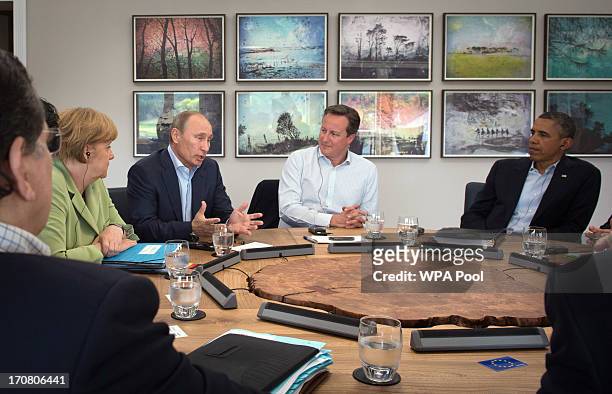 Russian President Vladimir Putin speaks as Prime Minister David Cameron holds a meeting with G8 leaders at the G8 venue of Lough Erne on June 18,...