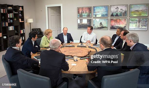 Russian President Vladimir Putin speaks as Prime Minister David Cameron holds a meeting with G8 leaders at the G8 venue of Lough Erne on June 18,...