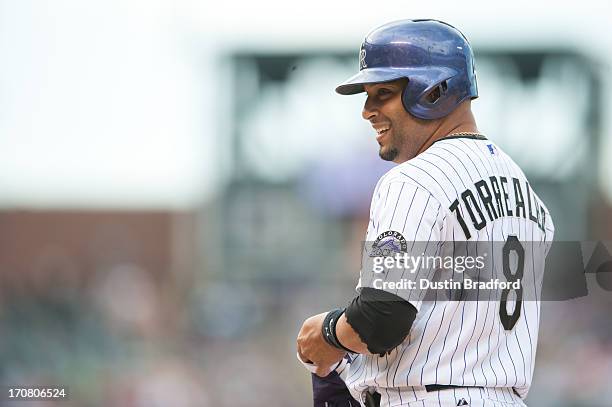 Yorvit Torrealba of the Colorado Rockies smiles back towards his bench after hitting a pinch hit single against the Philadelphia Phillies at Coors...