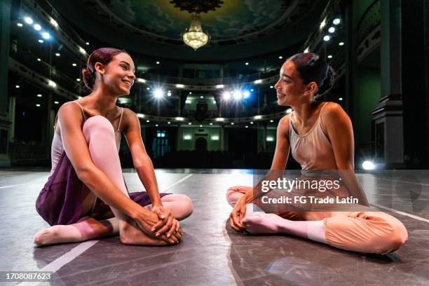 young ballerinas talking at sstage theater - two dancers stock pictures, royalty-free photos & images