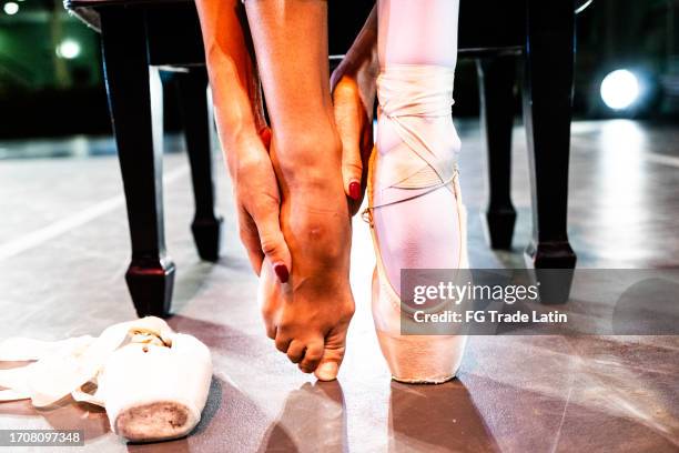 close-up of a ballerina getting dressed to dance at stage theater - ballet feet hurt stock pictures, royalty-free photos & images