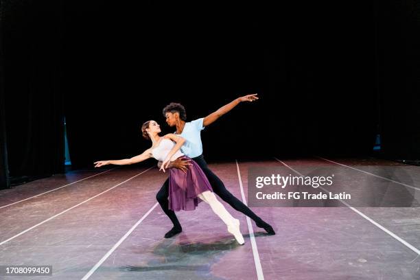 two dancers perfoming at stage theater - african ballet stock pictures, royalty-free photos & images