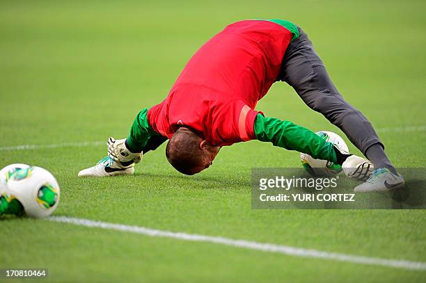 Brazil's goalkeeper Jefferson stretches during a training session in Fortaleza, northeastern Brazil, on the eve of their FIFA Confederations Cup...
