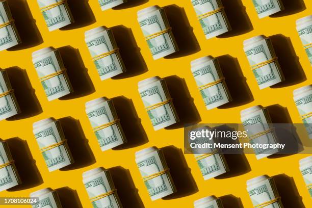 mosaic pattern of american dollar banknotes bills on the yellow background - pension ukraine stock pictures, royalty-free photos & images