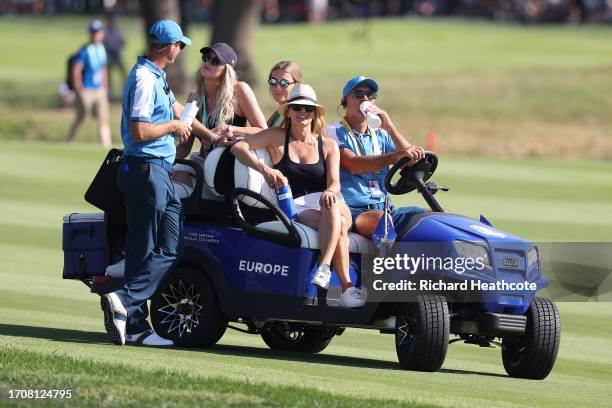 Nicolas Colsaerts, Vice Captain of Team Europe and his wife Rachel Colsaerts talk as Kate Rose and Shannon Hartley watch play during the Friday...