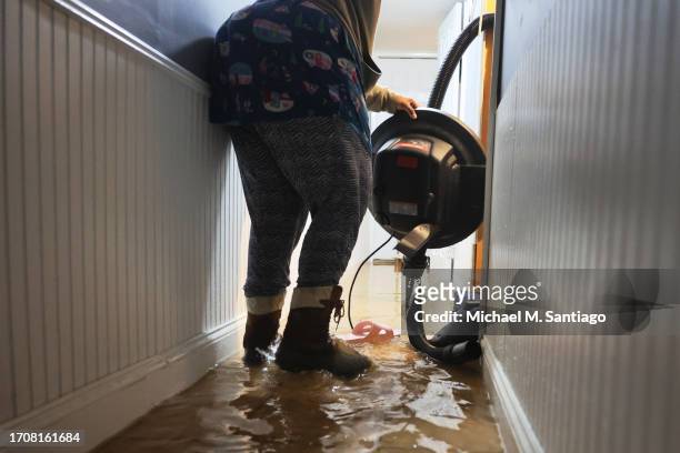 Person picks up a water pump in their flooded basement on E 10th Street amid a coastal storm on September 29, 2023 in the Flatbush neighborhood of...