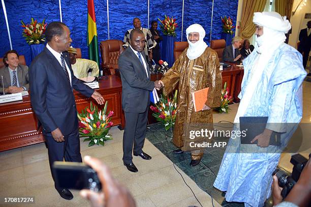 Mali's territorial administration minister, Colonel Moussa Sinko Coulibaly shakes hands with the secretary general of Mali's Tuareg MNLA group Bilal...