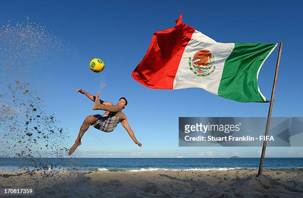 Fan of Mexico kicks a football on Copacabana beach on June 18, 2013 in Rio de Janeiro, Brazil.