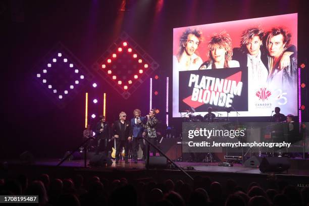 Jeanne Beker speaks with Sergio Galli, Chris Steffler, and Mark Holmes of Platinum Blonde during 2023 Canada's Rock Of Fame at Massey Hall on...