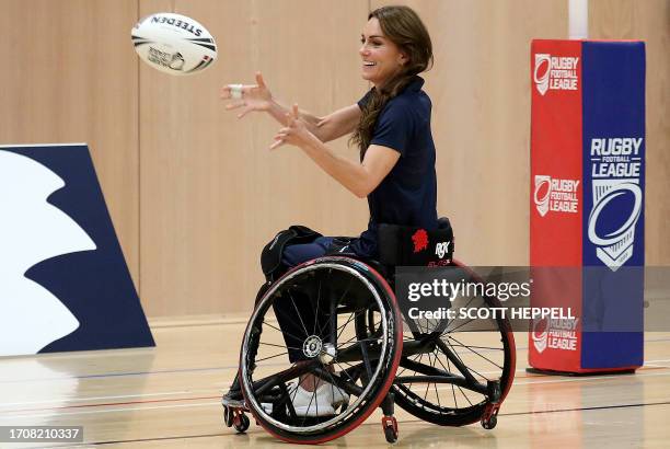 Britain's Catherine, Princess of Wales, tries wheelchair rugby as she joins a training session facilitated by members of the World Cup-winning...