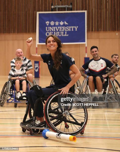 Britain's Catherine, Princess of Wales, reacts while trying wheelchair rugby as she joins a training session facilitated by members of the World...