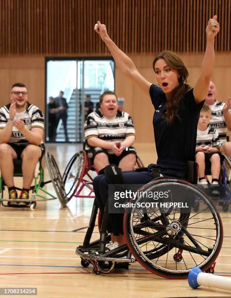 Britain's Catherine, Princess of Wales, reacts while trying wheelchair rugby as she joins a training session facilitated by members of the World...