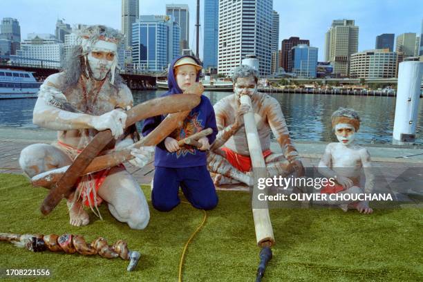 Yidaki Didge and Aboriginal dance group perform with 7 years old Amelia Street in Sydney on July 3, 1996 as part of Bandemonium, Darling Harbour's...