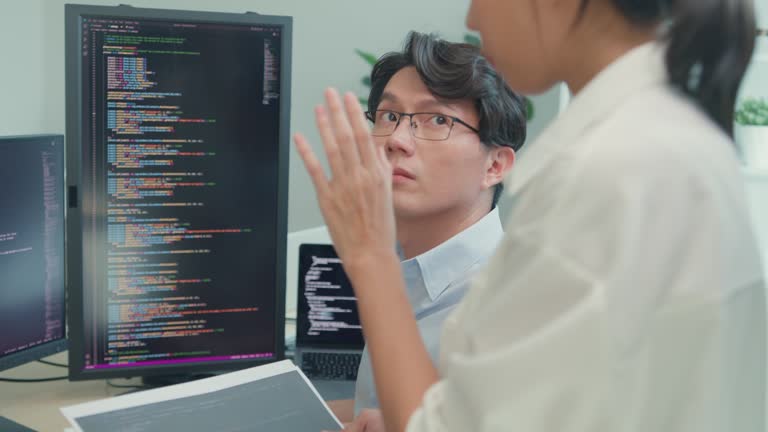 Closeup group of Asian people software developers using computer to ...