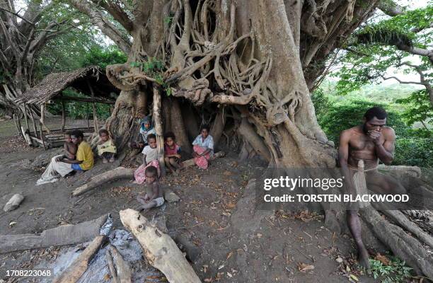 Vanuatu-Britain-religion-royals,FEATURE" by Madeleine Coorey Sikor Natuan and members of his tribe sit under the banyan tree used for kava ceremonies...