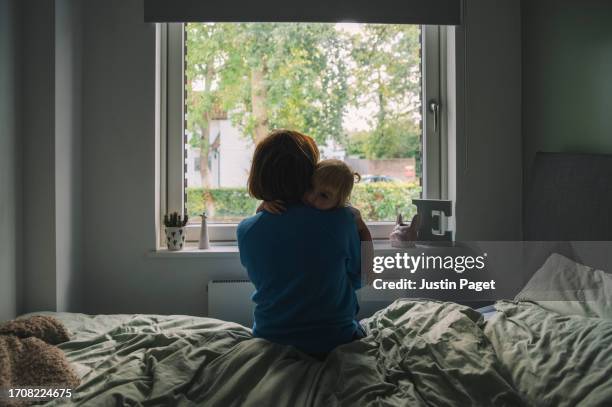 mother and baby bed window - sad child alone stock pictures, royalty-free photos & images