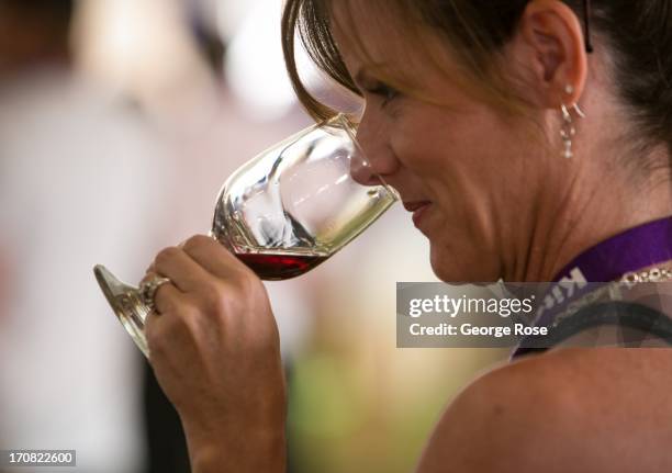 Woman samples a taste of wine during the Aspen Food & Wine Classic Grand Tastings on June 14 in Aspen, Colorado. The 31st Annual Food & Wine Classic...