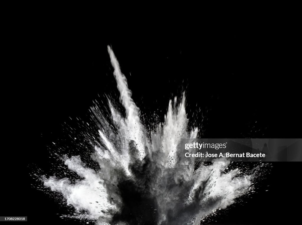 Shock wave from an explosion of dust and smoke on a black background.