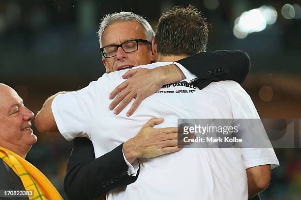 David Gallop celebrates with Socceroos captain Lucas Neill after victory during the FIFA 2014 World Cup Asian Qualifier match between the Australian...
