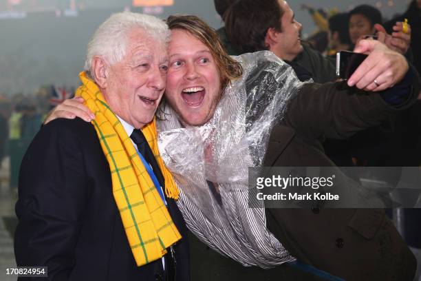Chariman Frank Lowy poses for a photo as he celebrates with a member of the crowd after victory during the FIFA 2014 World Cup Asian Qualifier match...