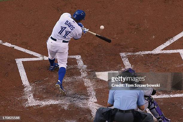 Rajai Davis of the Toronto Blue Jays hits an RBI double in the first inning during MLB game action against the Colorado Rockies on June 18, 2013 at...