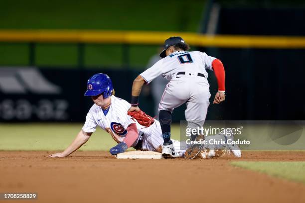 James Triantos of the Mesa Solar Sox is out attempting to steal second base as Nasim Nunez of the Peoria Javelinas applies the tag during the game...