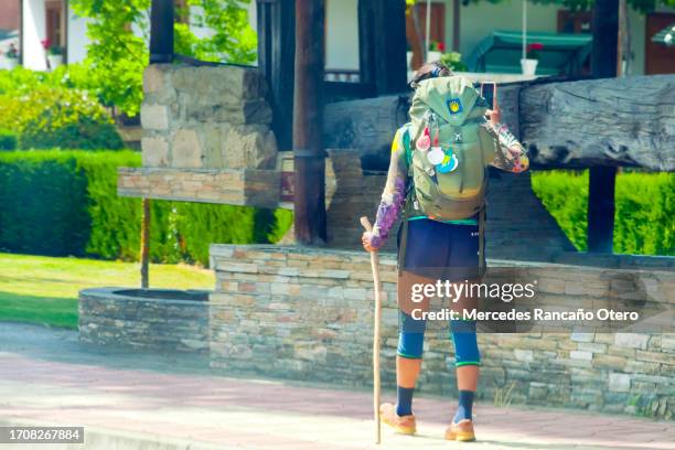 pilgrim in 'camino de santiago', backpack and scallop shell. - león province spain stock pictures, royalty-free photos & images