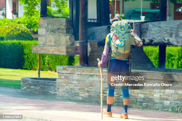 pilgrim in 'camino de santiago', backpack and scallop shell. - sunny leon stock pictures, royalty-free photos & images